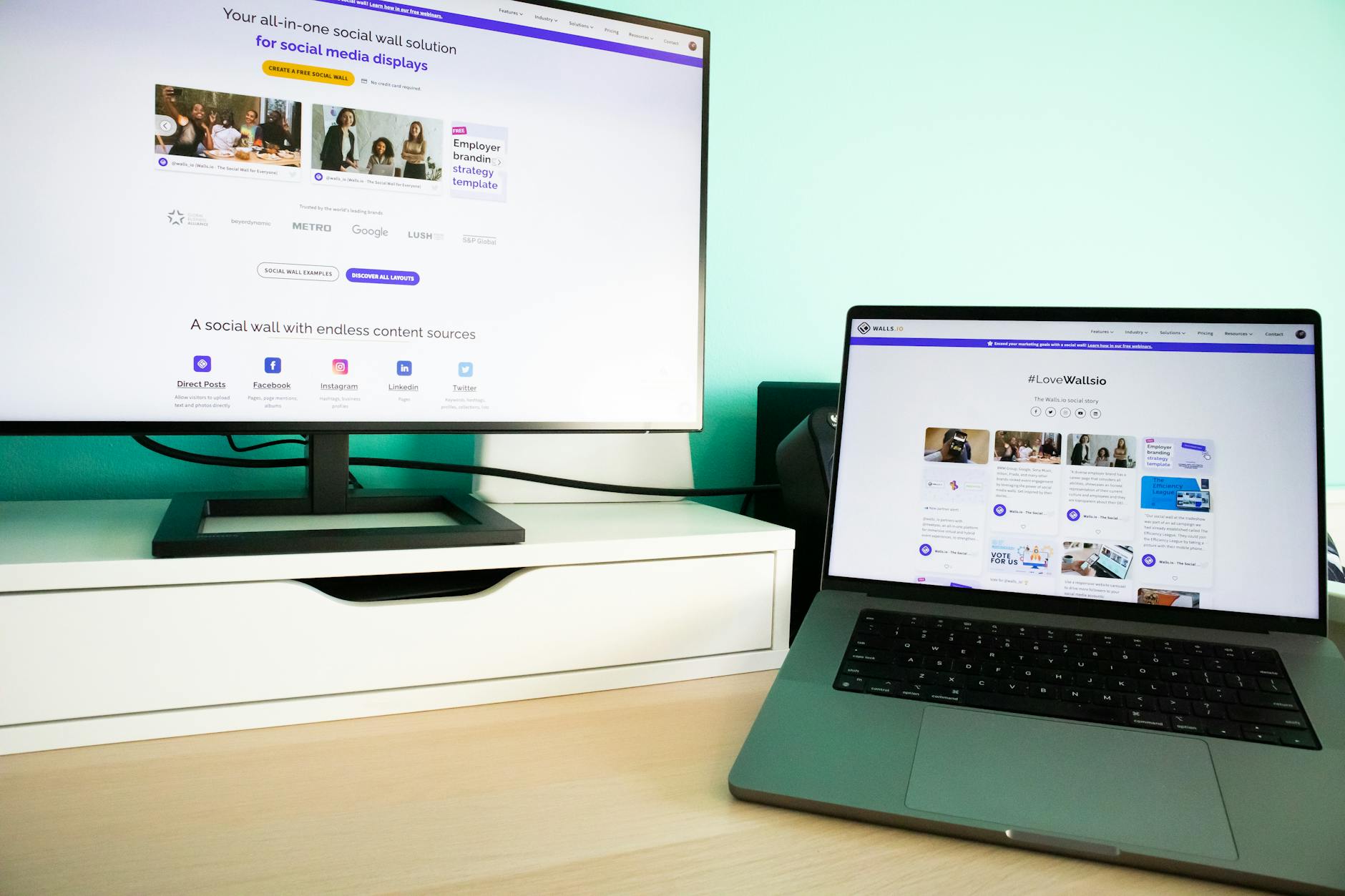 A computer monitor and laptop displaying social media content